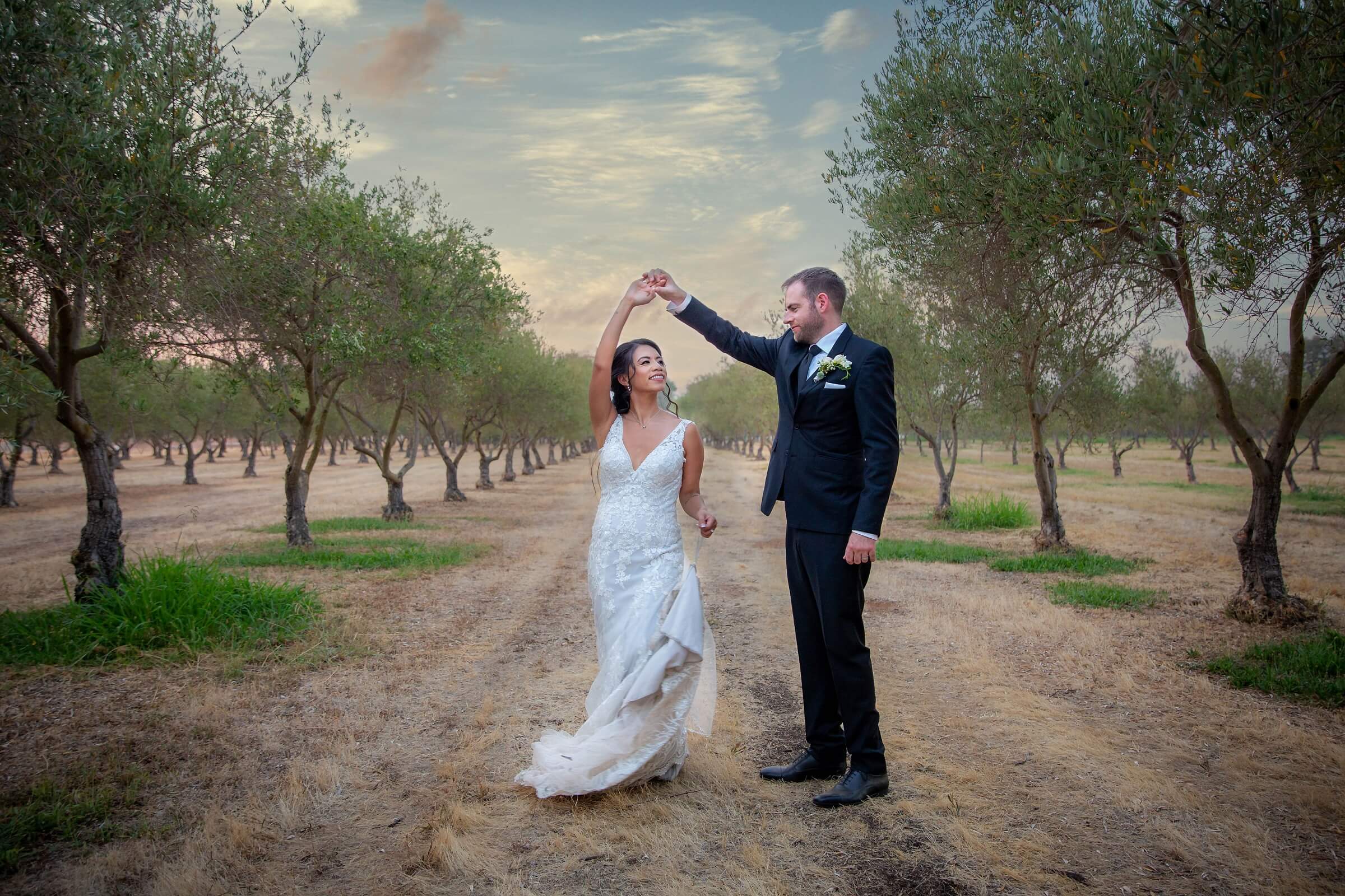 professional photography videography service portrait of groom twirling bride in vineyard